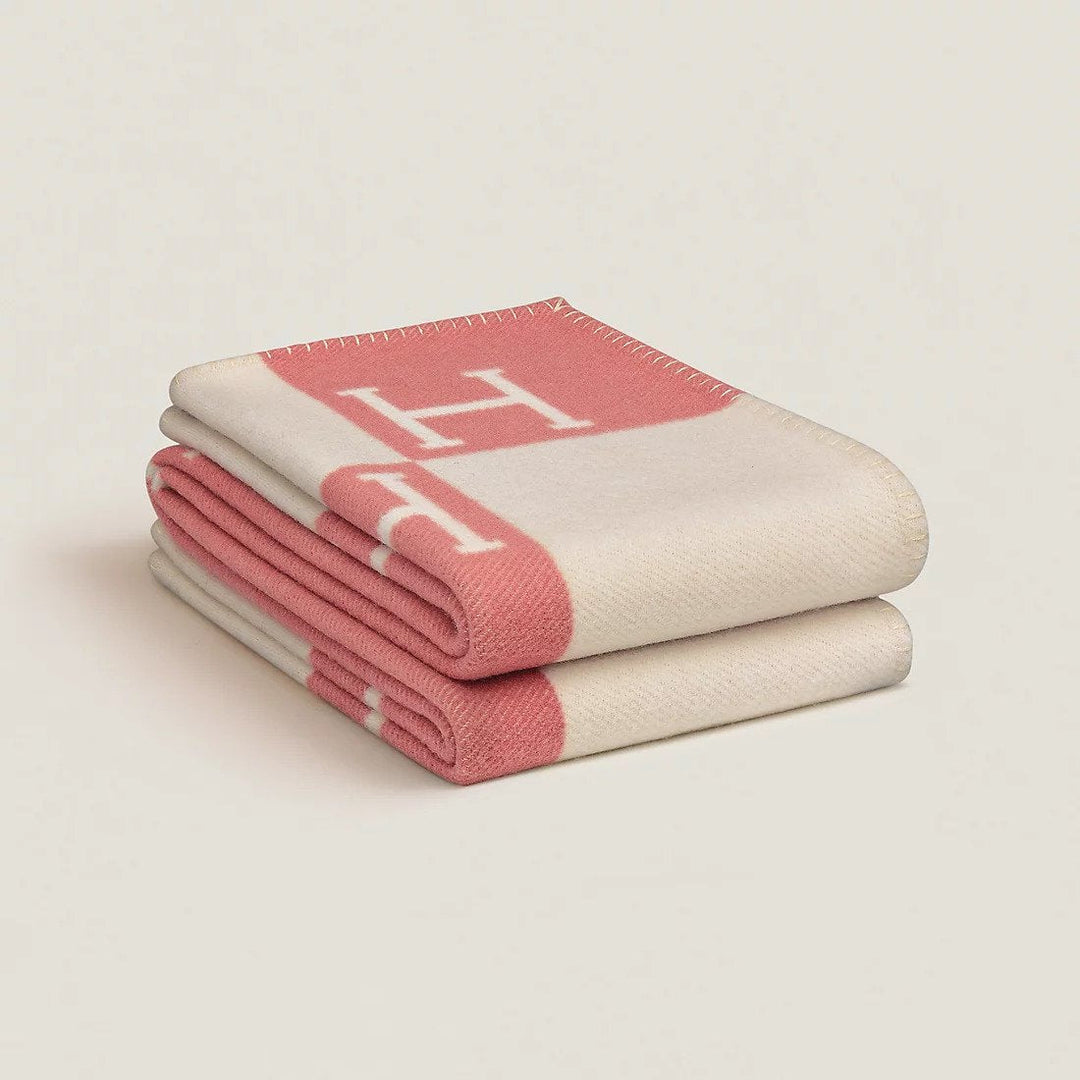 Folded rectangular throw blanket with contrasting blocks and letter motifs