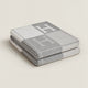 Folded rectangular throw blanket with contrasting blocks and letter motifs