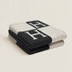 Folded rectangular throw blanket with contrasting blocks and letter motifs