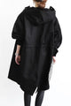 Women's oversized hooded mid-length trench coat with button front and side pockets
