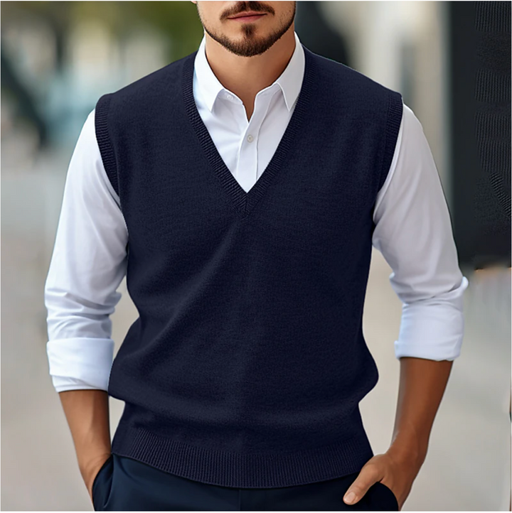 Men's sleeveless V-neck sweater vest with ribbed trim layered over a white shirt