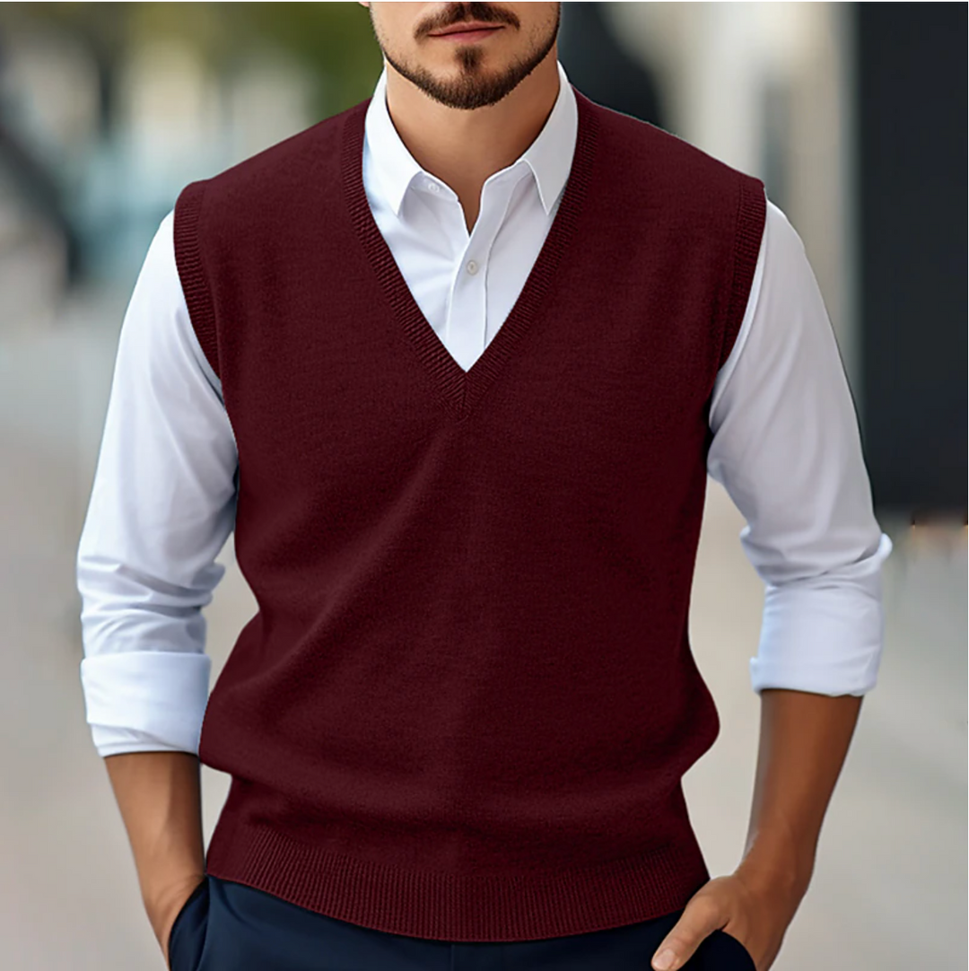 Men's sleeveless V-neck sweater vest with ribbed trim layered over a white shirt