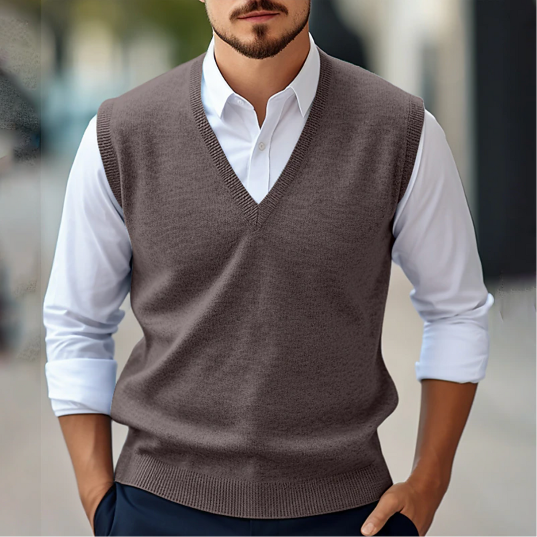 Men's sleeveless V-neck sweater vest with ribbed trim layered over a white shirt