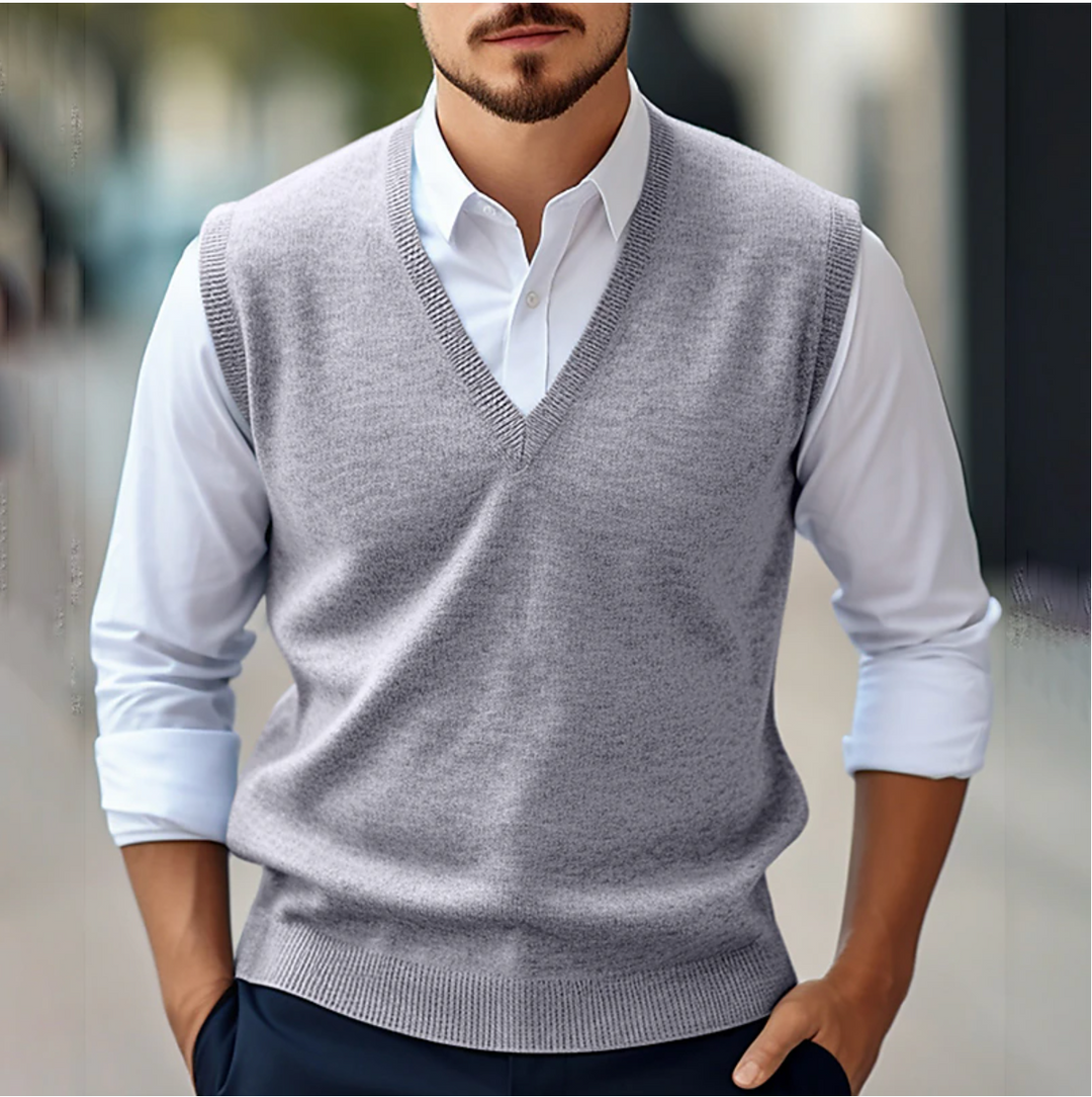 Men's sleeveless V-neck sweater vest with ribbed trim layered over a white shirt