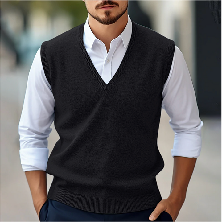 Men's sleeveless V-neck sweater vest with ribbed trim layered over a white shirt