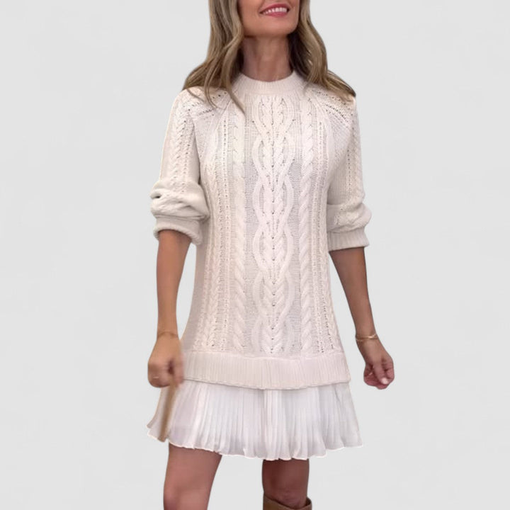 Women's cable knit dress with crew neck, long sleeves and pleated hem