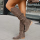 Women's high slouchy tube boots with flat heels and strap details