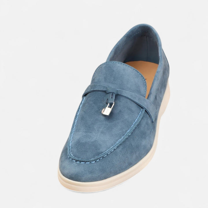Men's textured slip-on loafers with flat soles, stitched apron detail and decorative toggle trim