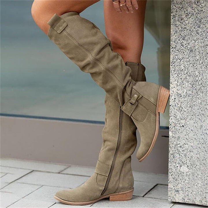 Women's high slouchy tube boots with flat heels and strap details