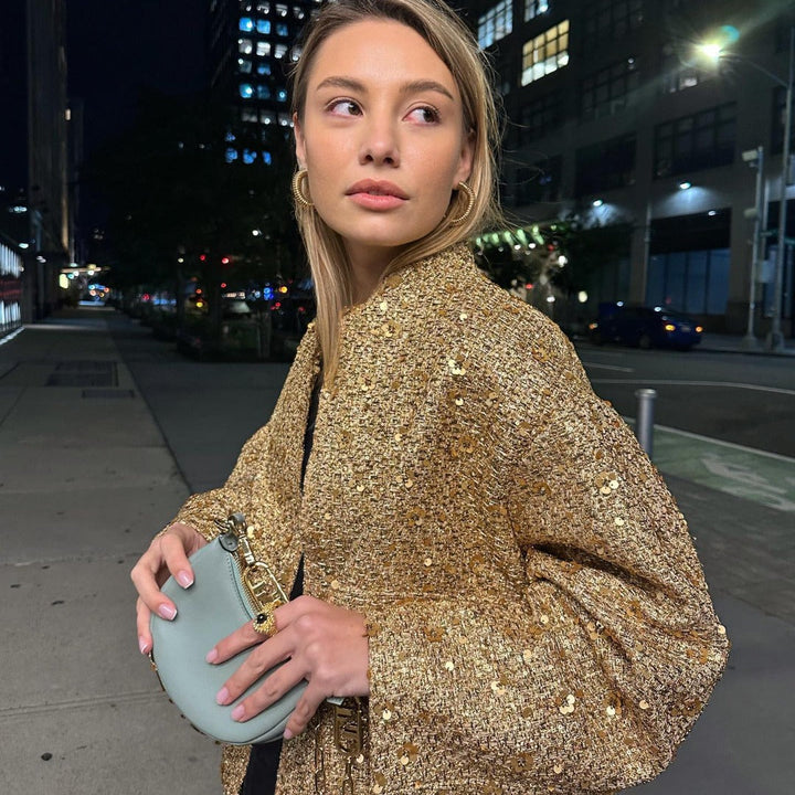 Women's textured metallic jacket with stand collar, long sleeves and front pockets