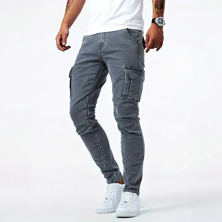 Men's tapered cargo jeans with multiple thigh pockets and panel detailing