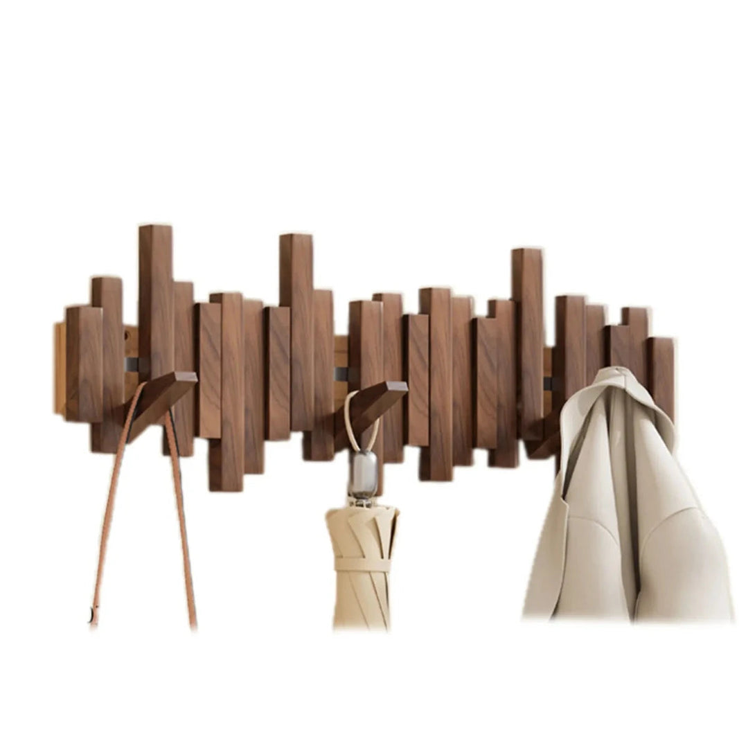 Wall-mounted wooden coat rack with staggered piano-style slats and angled hooks