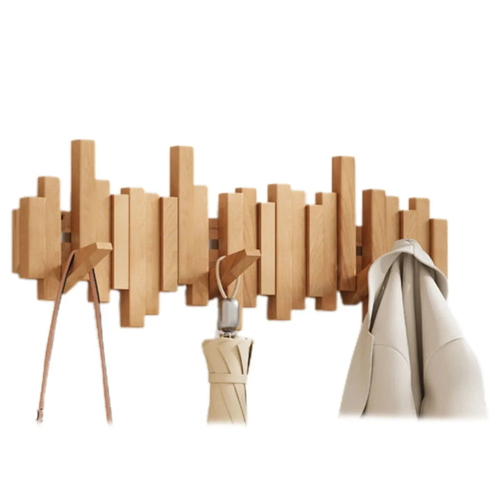 Wall-mounted wooden coat rack with staggered piano-style slats and angled hooks