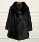 Women's black faux fur coat with shawl collar and curved hem