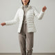 Women's quilted jacket with stand collar, long sleeves and zipped pockets