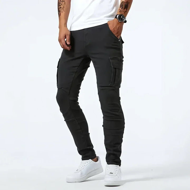 Men's tapered cargo jeans with multiple thigh pockets and panel detailing