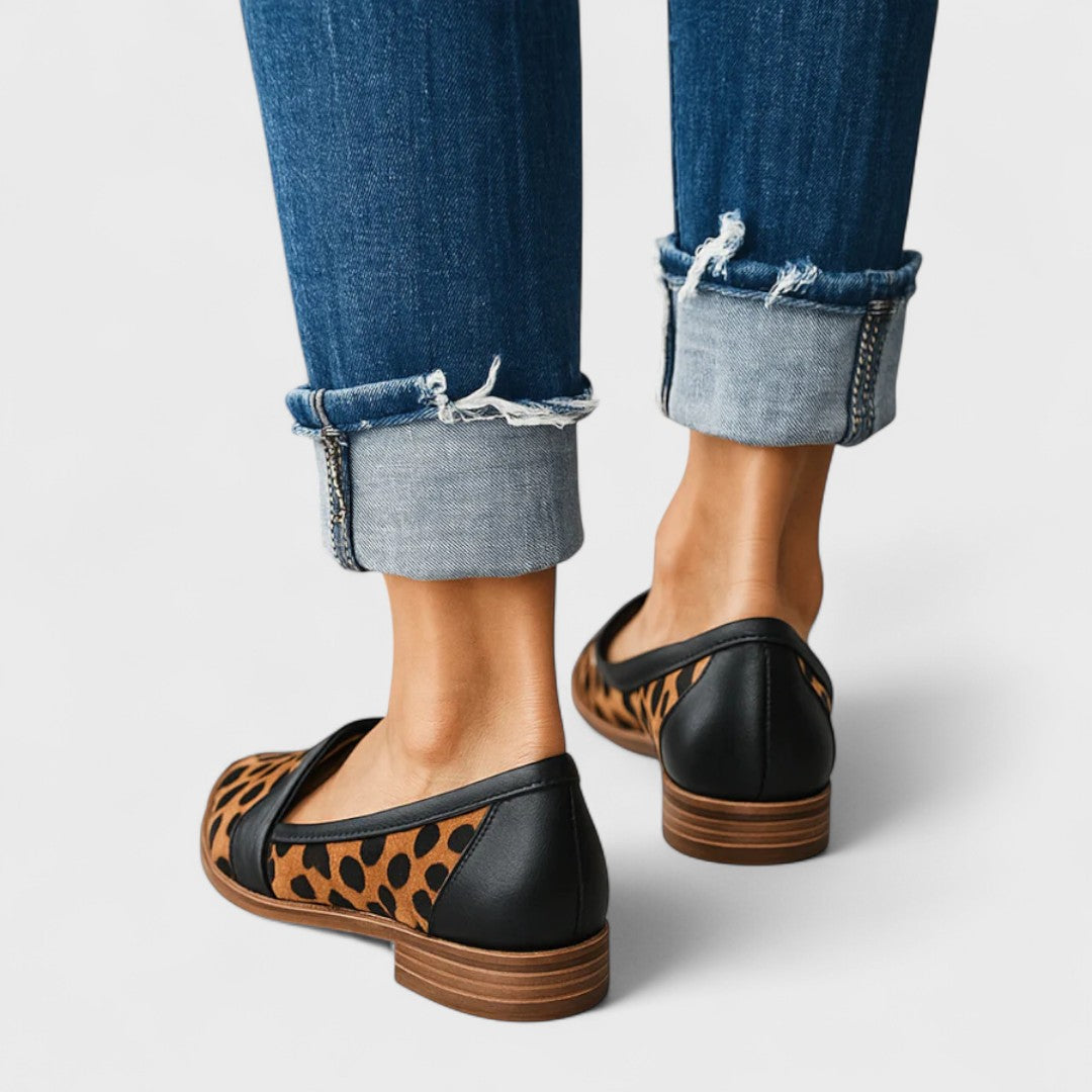 Women's black pointed-toe penny loafers with low heels