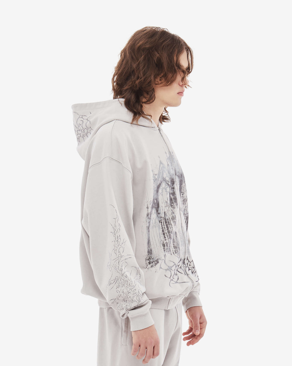Light coloured zip up hoodie with cathedral graphic print and hood