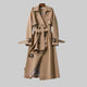 Women's long belted double-breasted trench coat with lapel collar and buckle cuffs