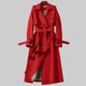 Women's long belted double-breasted trench coat with lapel collar and buckle cuffs