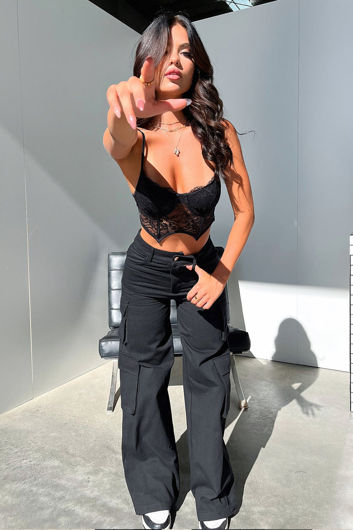 Women's black high-waisted wide-leg cargo pants with utility pockets