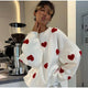 Women's patterned knit sweater with crew neck, long sleeves and contrasting motifs