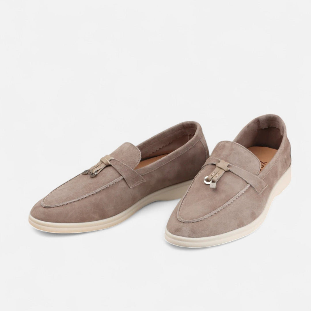 Men's textured slip-on loafers with flat soles, stitched apron detail and decorative toggle trim