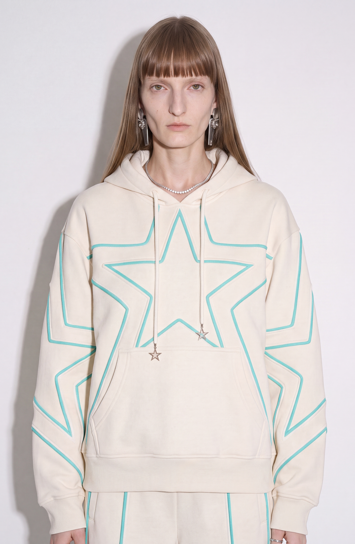 Cream hoodie with turquoise outlined star detailing, drawstring hood and kangaroo pocket