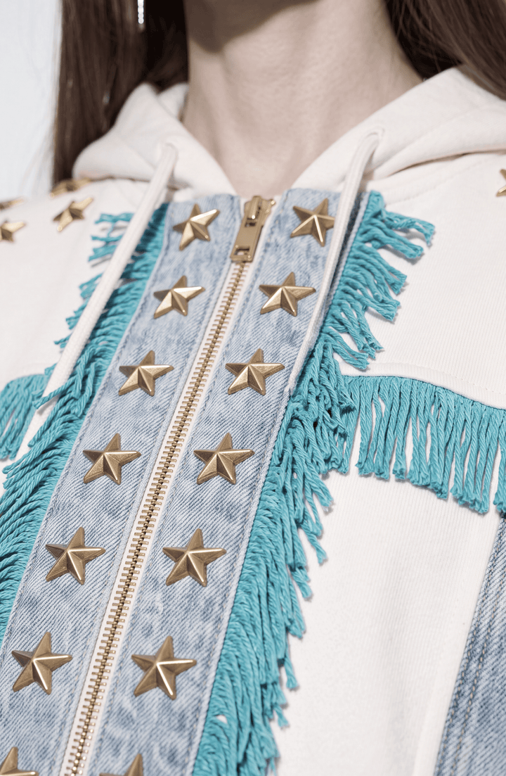 White hooded zip hoodie with gold stars, turquoise fringe and blue panels