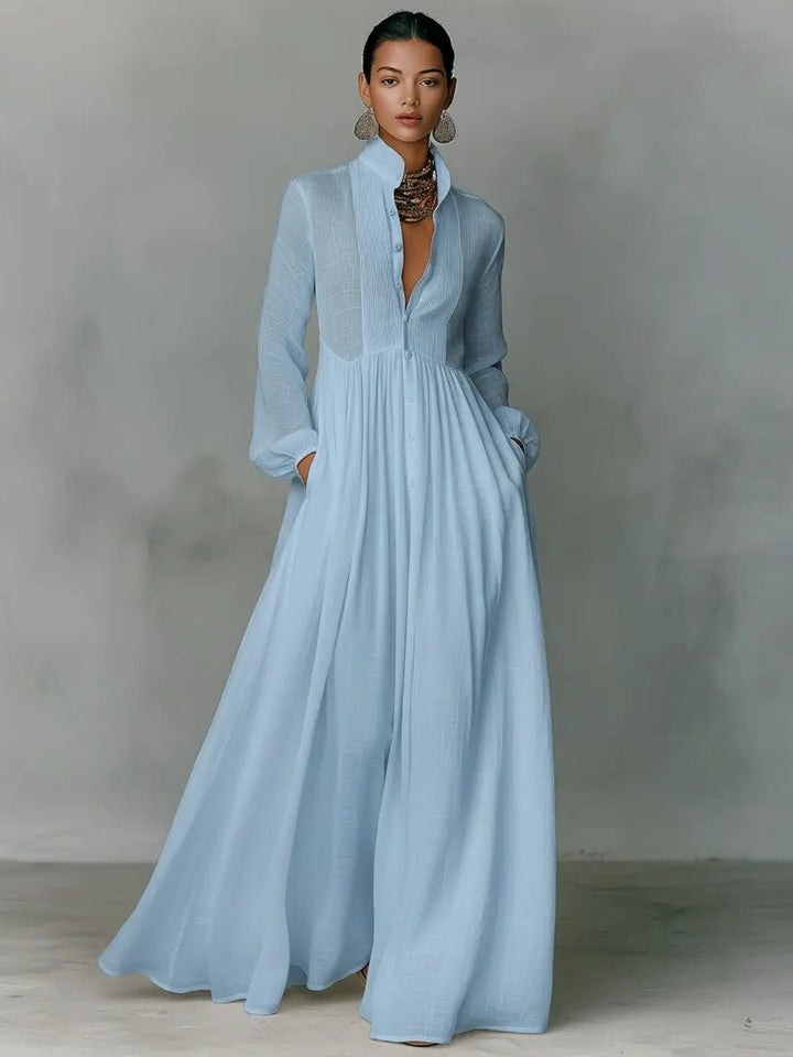 Women's maxi shirt dress with stand collar and long sleeves in white with pleated skirt