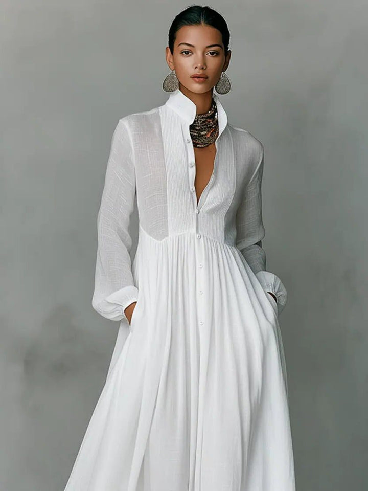 Women's maxi shirt dress with stand collar and long sleeves in white with pleated skirt