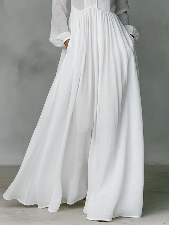 Women's maxi shirt dress with stand collar and long sleeves in white with pleated skirt