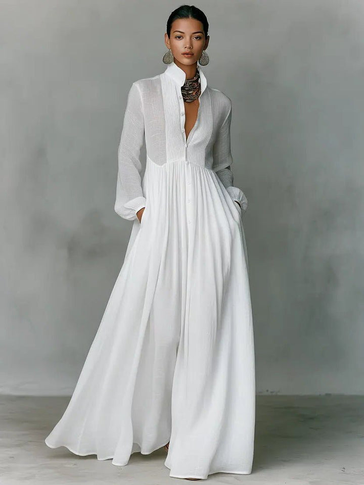 Women's maxi shirt dress with stand collar and long sleeves in white with pleated skirt