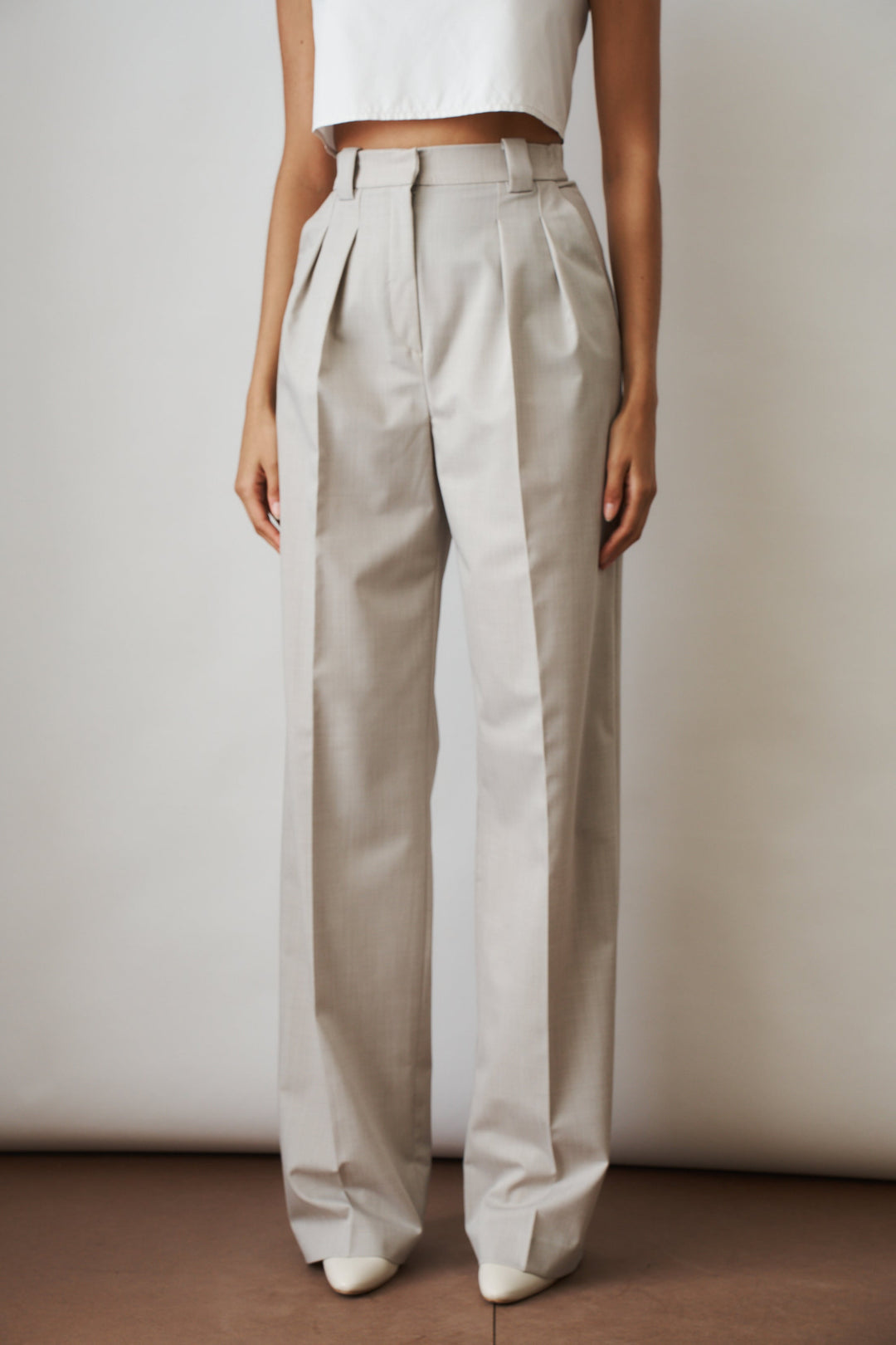 Women's beige high-rise wide-leg pants with front pleats and side pockets