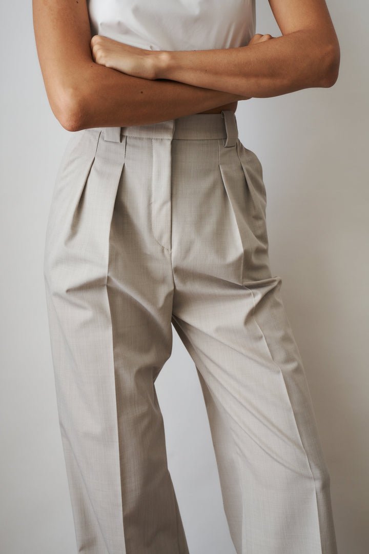 Women's beige high-rise wide-leg pants with front pleats and side pockets