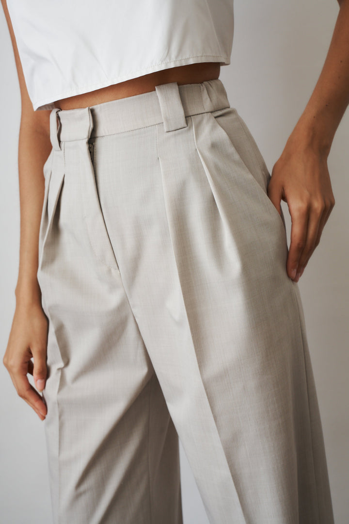 Women's beige high-rise wide-leg pants with front pleats and side pockets