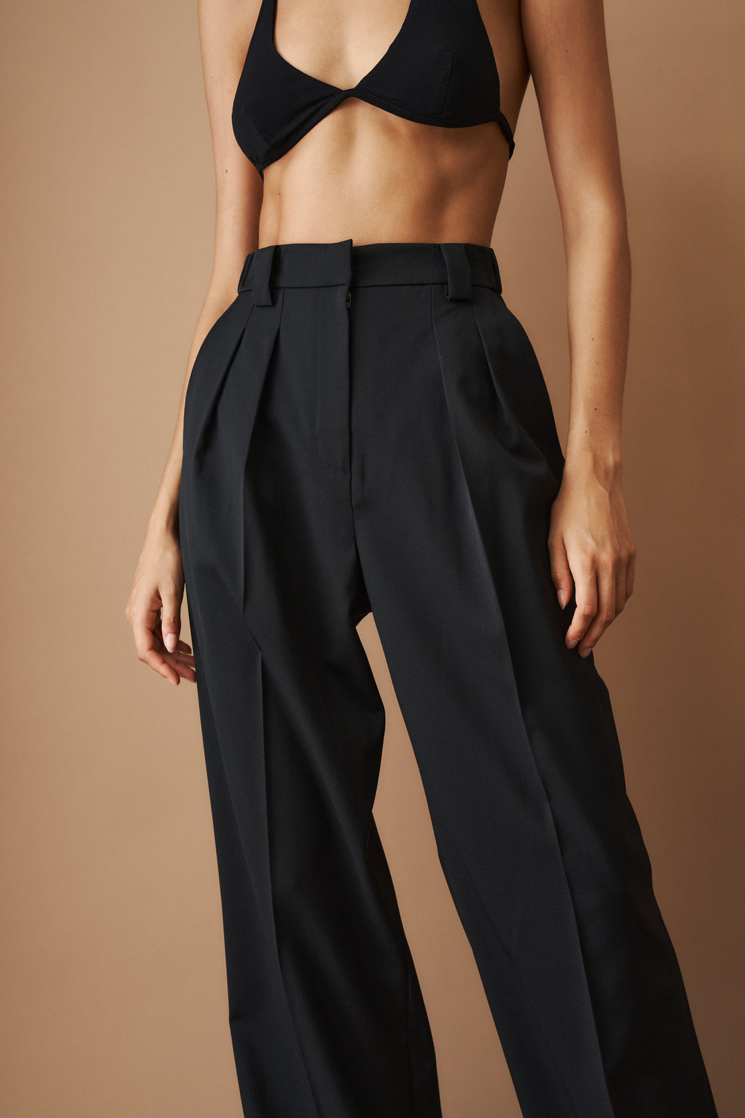Women's black high-waisted pleated wide-leg pants with belt loops