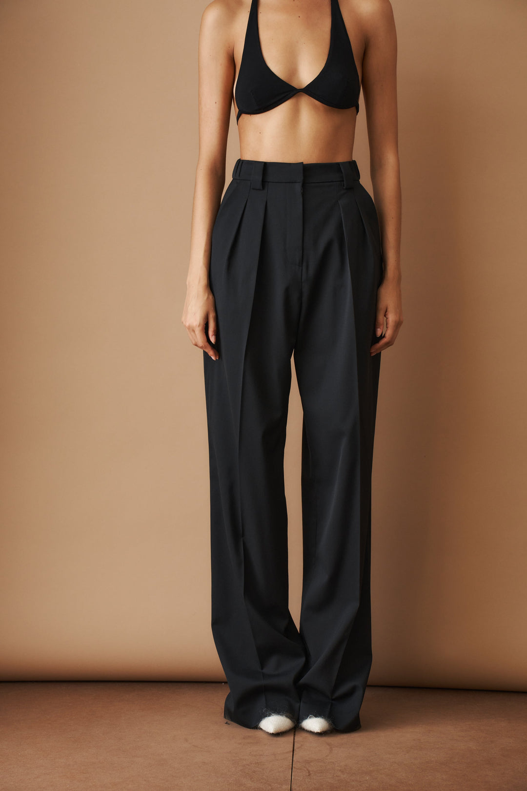 Women's black high-waisted pleated wide-leg pants with belt loops