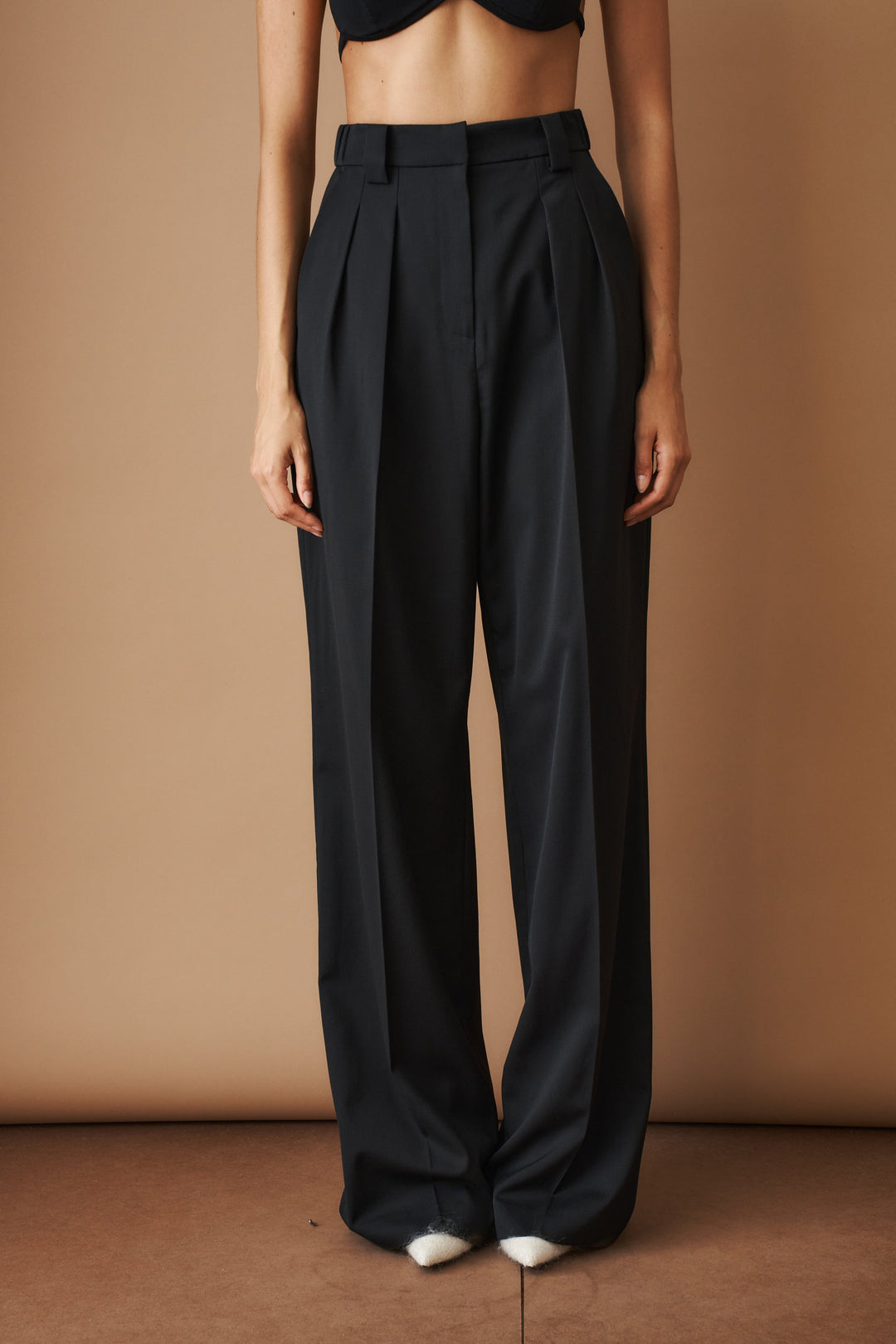 Women's black high-waisted pleated wide-leg pants with belt loops