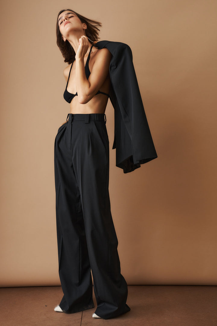 Women's black high-waisted pleated wide-leg pants with belt loops