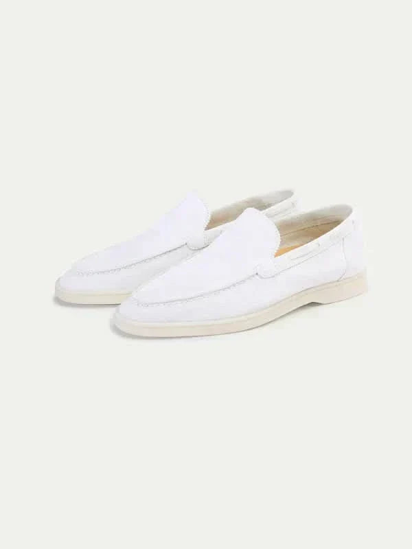 Men's white moc toe slip-on loafers with stitched detailing and flat soles