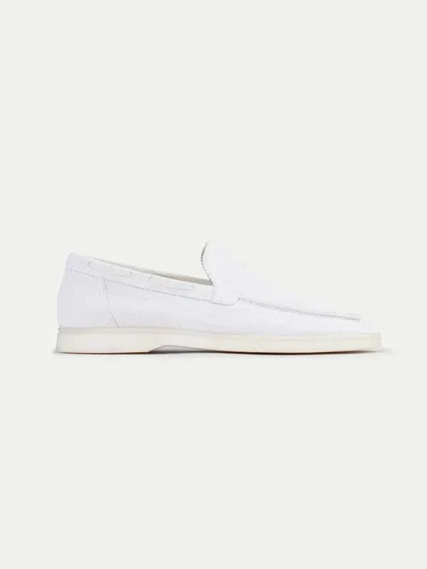 Men's white moc toe slip-on loafers with stitched detailing and flat soles
