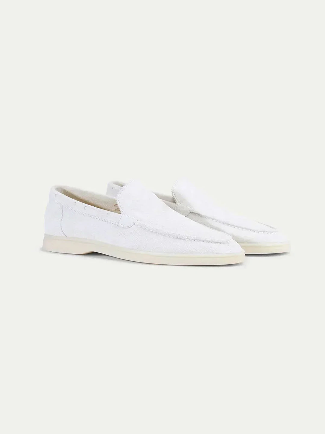 Men's white moc toe slip-on loafers with stitched detailing and flat soles