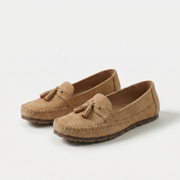 Women's slip-on tassel loafers with moccasin stitching and flat textured soles
