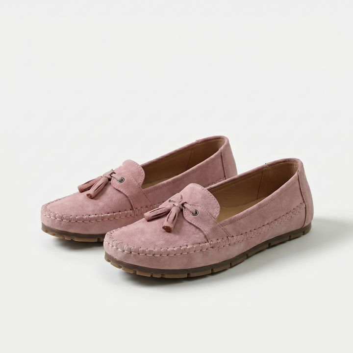 Women's slip-on tassel loafers with moccasin stitching and flat textured soles