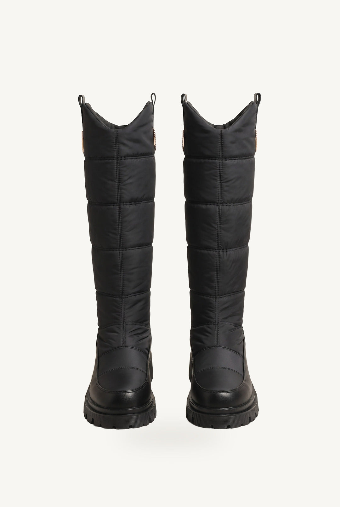 Knee-high quilted puffer boots with chunky lug soles