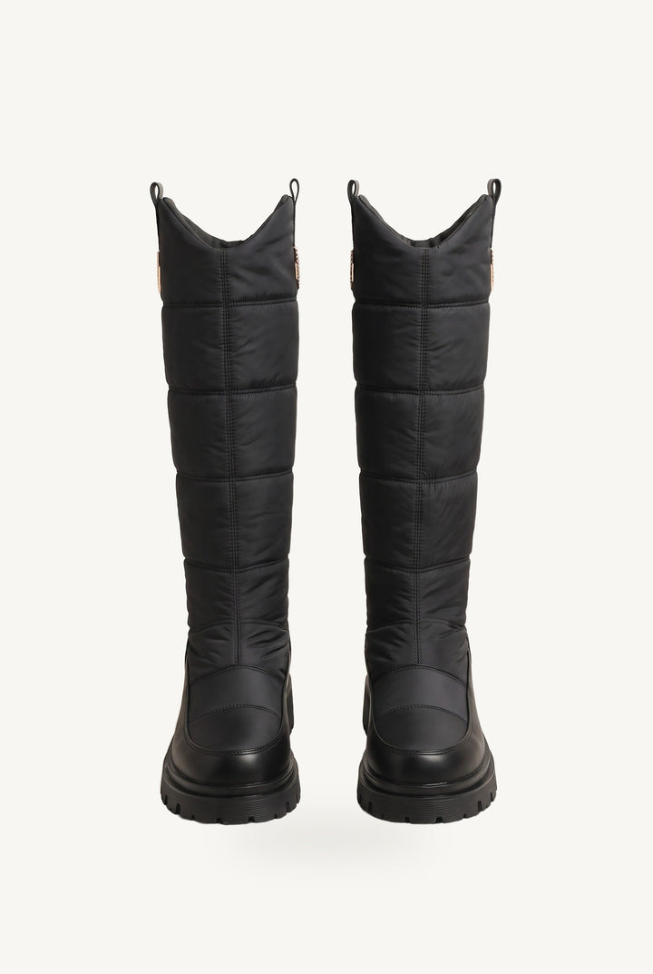 Knee-high quilted puffer boots with chunky lug soles