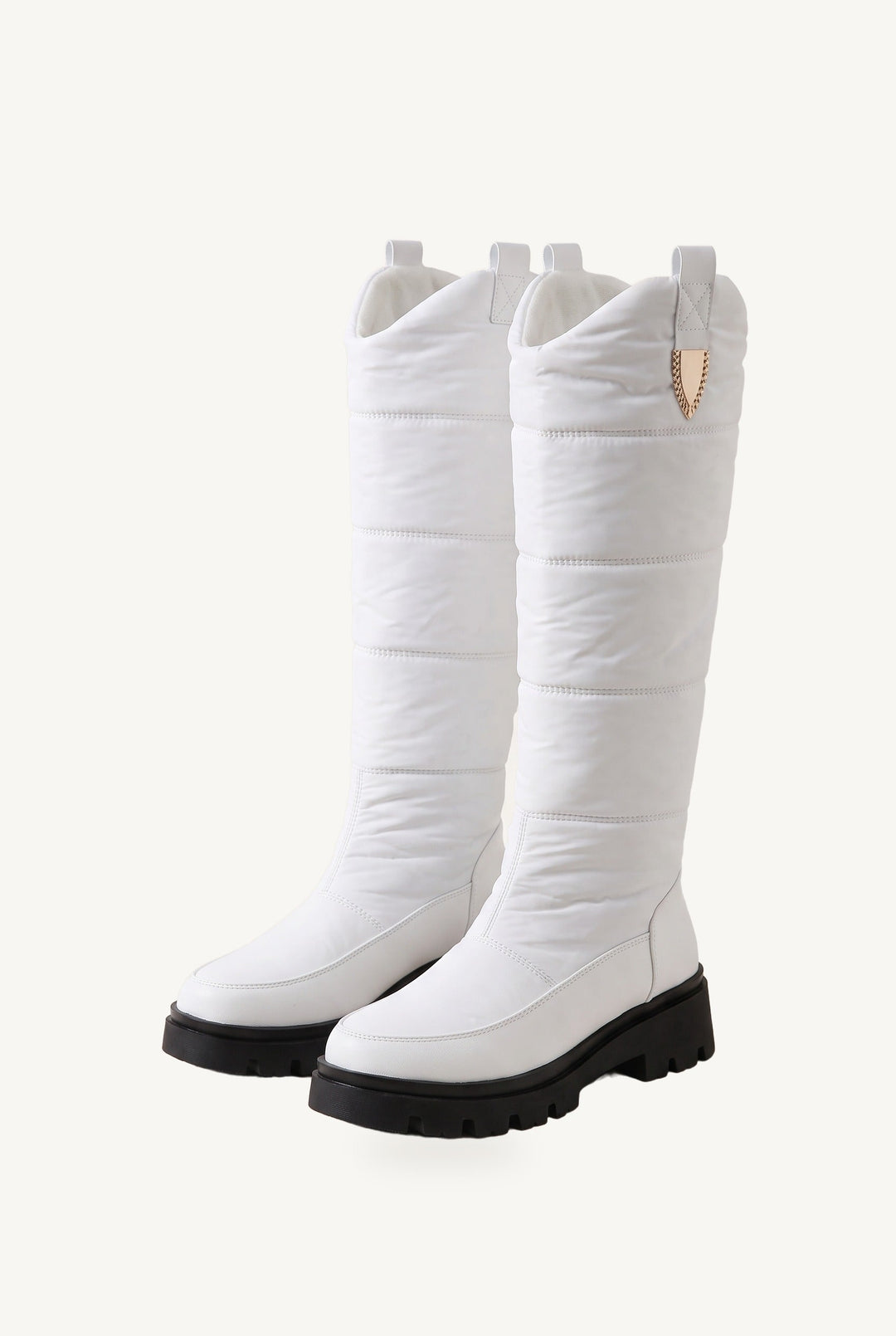 Knee-high quilted puffer boots with chunky lug soles