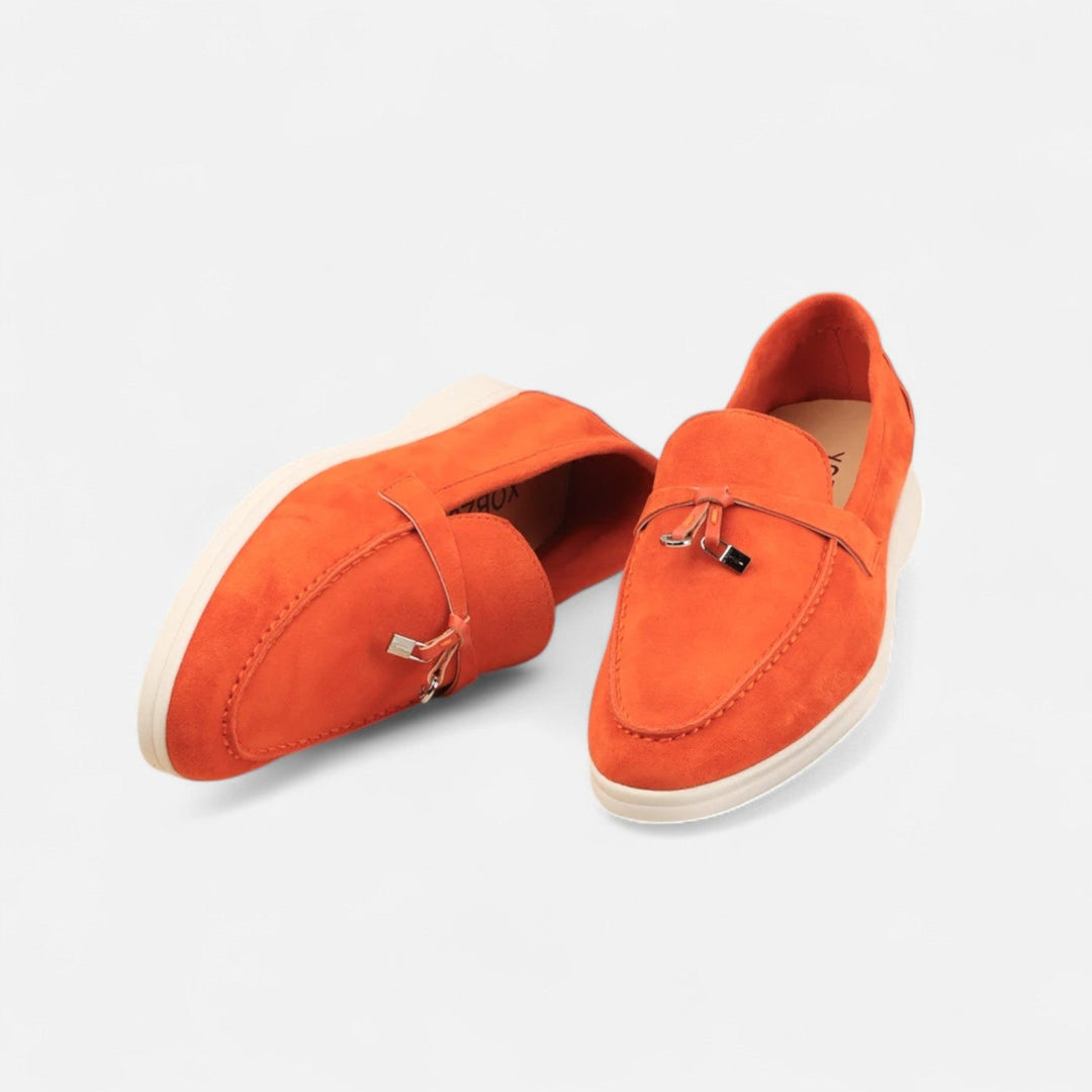 Men's textured slip-on loafers with flat soles, stitched apron detail and decorative toggle trim