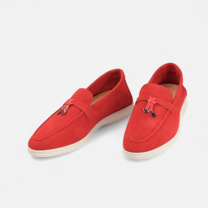 Men's textured slip-on loafers with flat soles, stitched apron detail and decorative toggle trim
